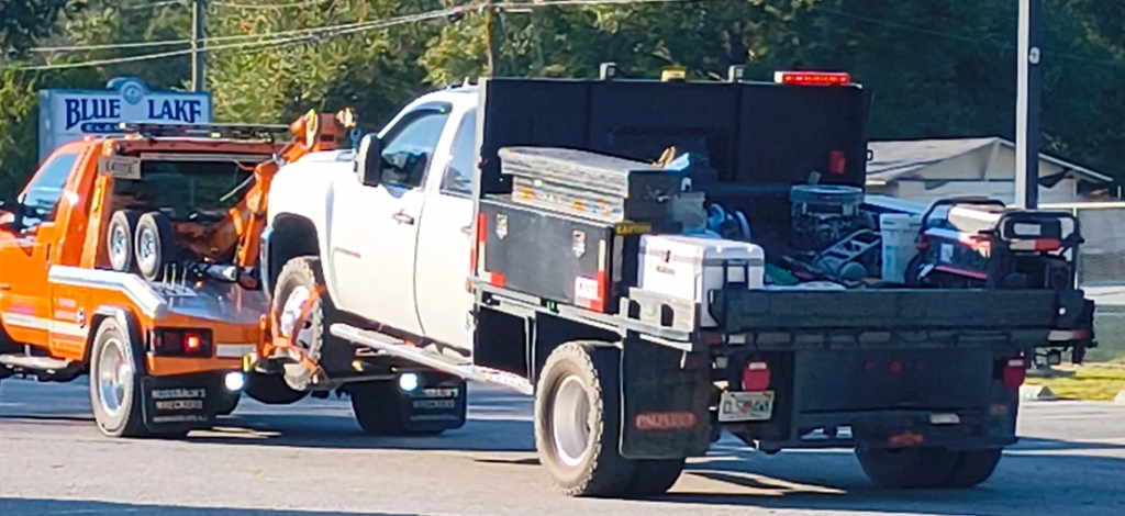 White service truck being towed by CFL Fast Tow
